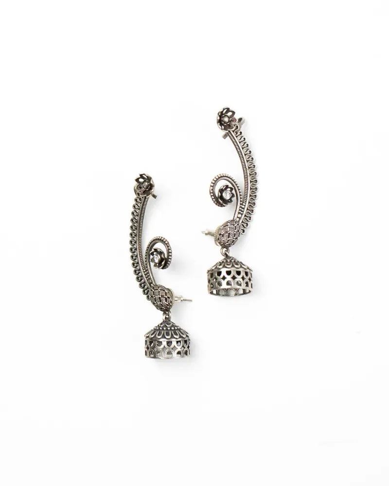 Pair of ornate silver earrings on a white background