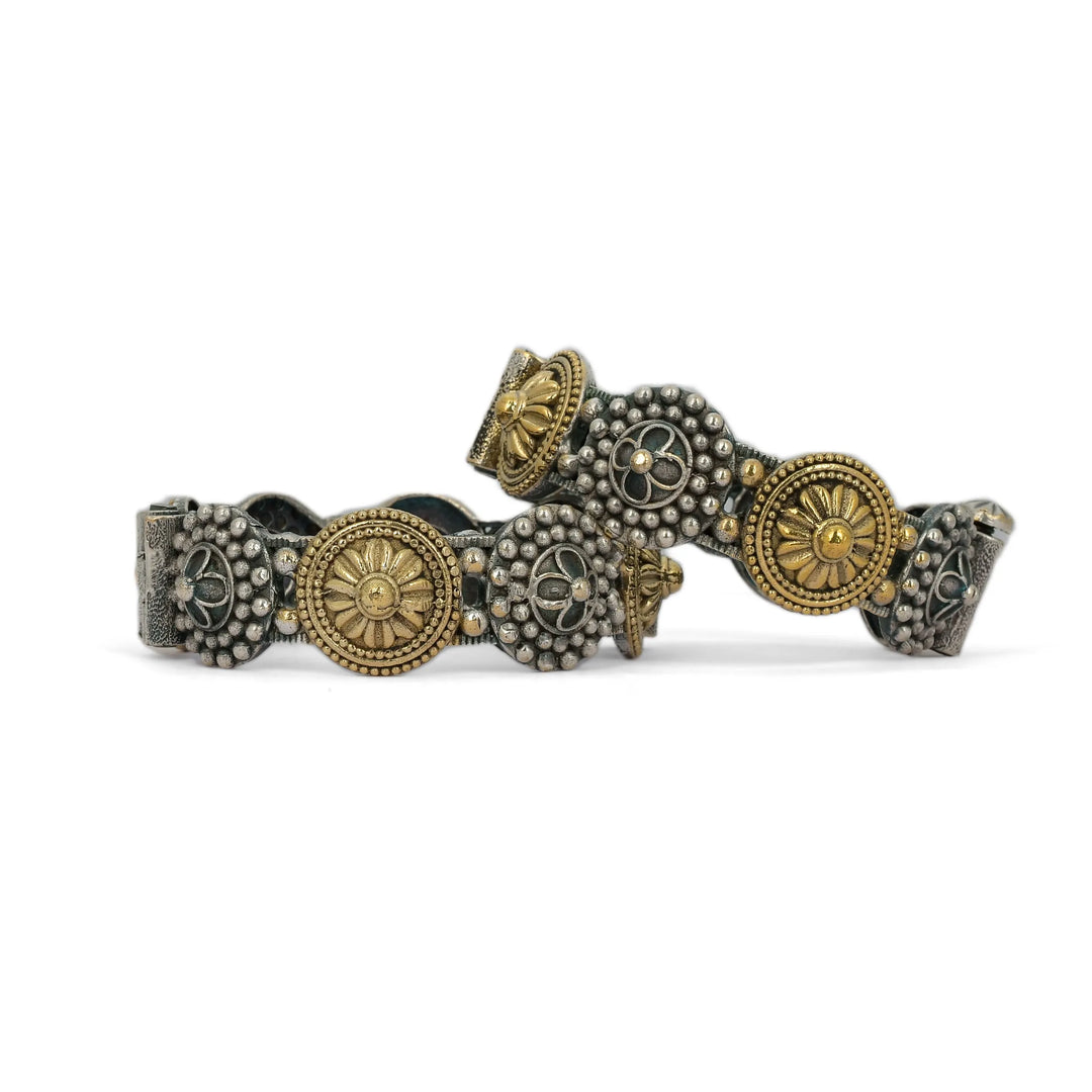 Two decorative bracelet with gold and silver elements on a white background